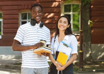 African American Male Student Standing with Latino Female Student